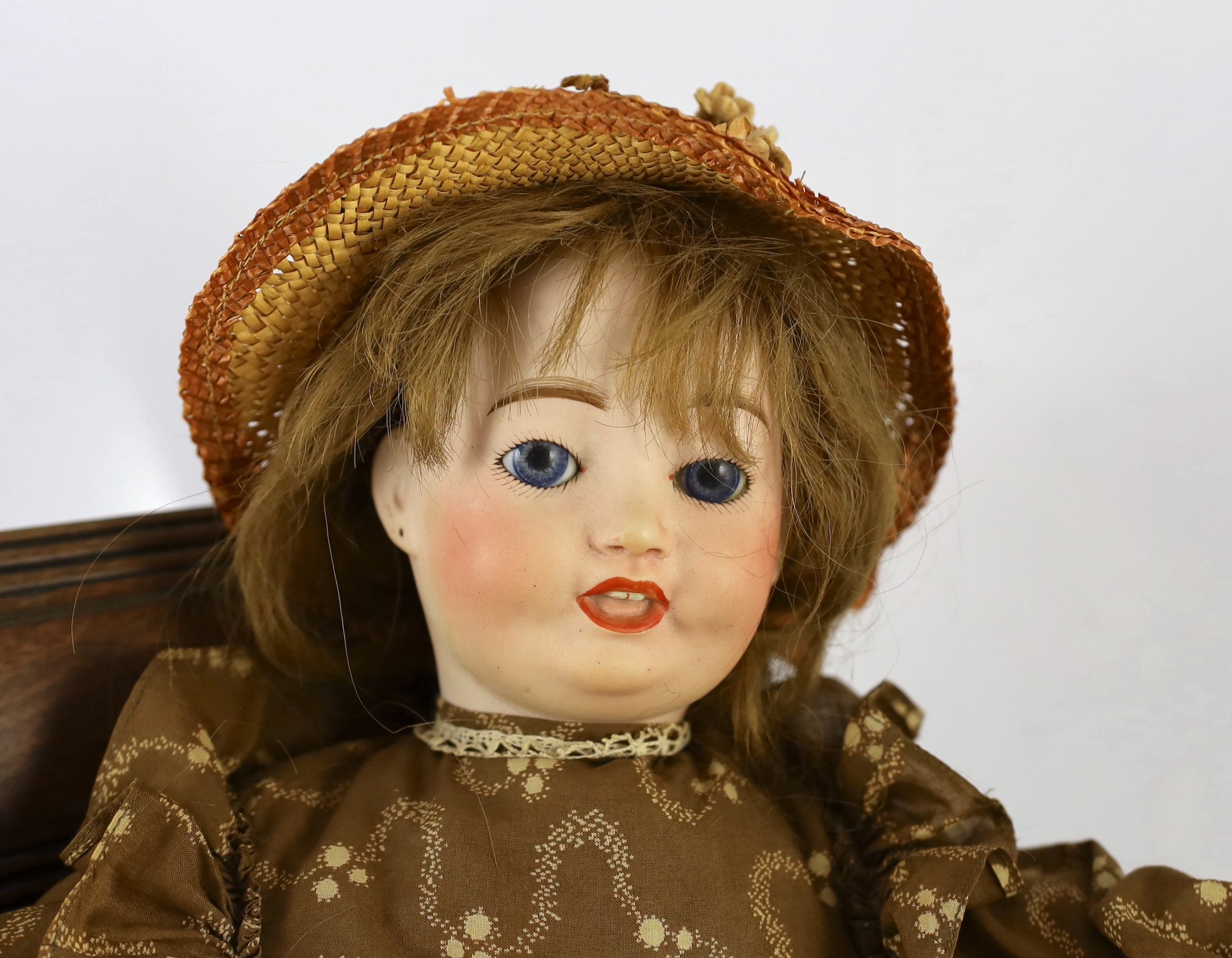 An Ed Tasson bisque doll, French, circa 1928, 21in. Please note the chair is for display purposes only.